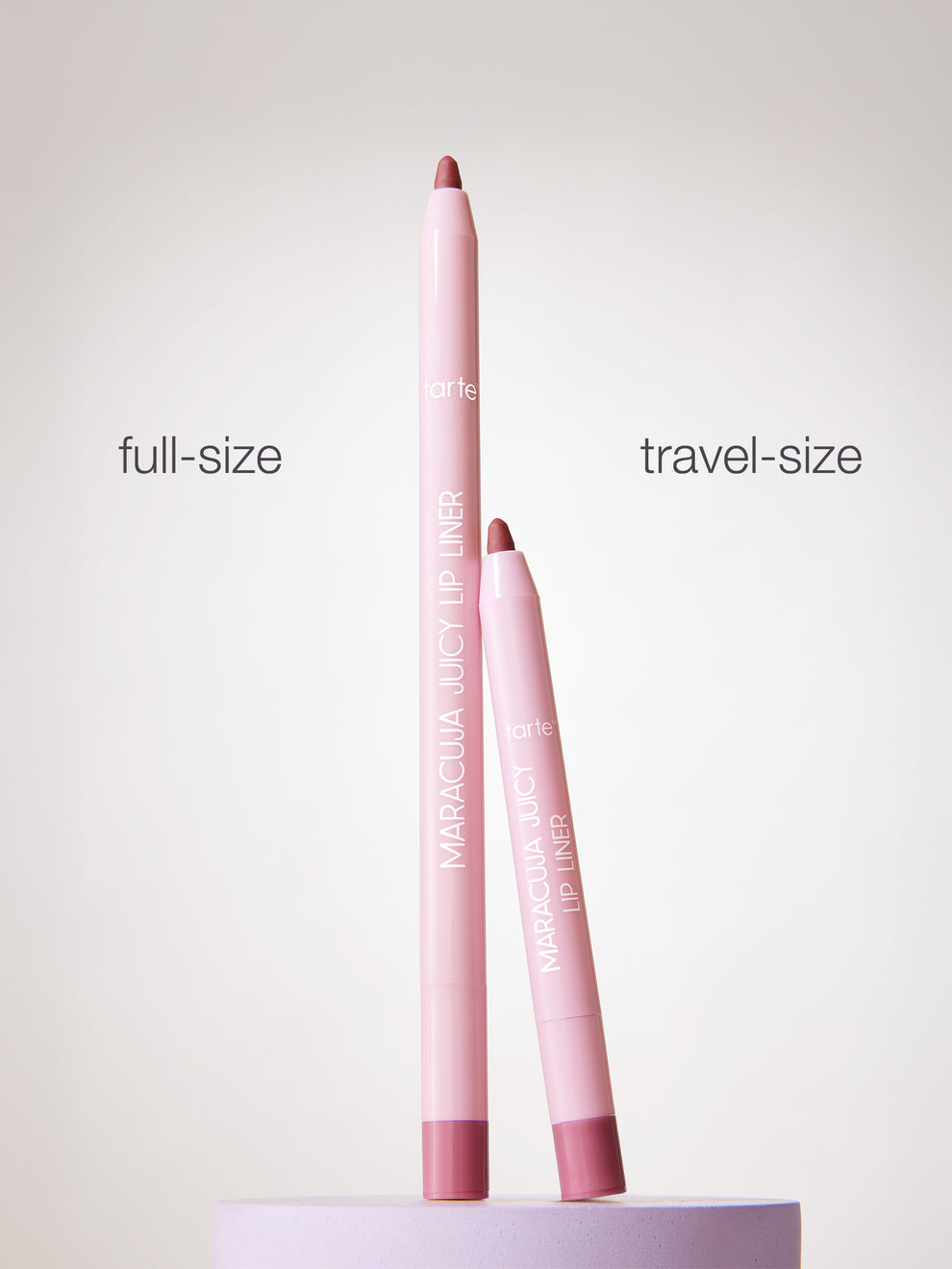 Two pink lip liners, one full-size and one travel-size, on a white background.